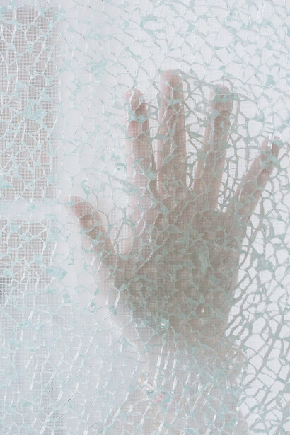 A cracked mirror represents an identity crisis faced by the protagonist