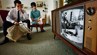 A family watches televised war coverage on the evening new