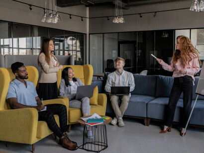Colleagues gathered around a whiteboard, brainstorming strategies to overcome self-doubt and unlock their full potential in a supportive work environment