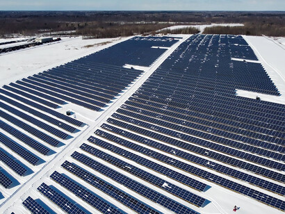 Embracing the essence of clean energy, solar panels stand resiliently on the snow-covered landscapes of Ontario, Canada, harnessing the power of solar energy amidst the serene winter backdrop