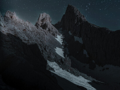A beautiful, barely snowed mountain range at night