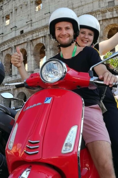 A couple seeing the Roman Colosseum on a Vespa