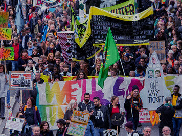 Signs of hope and resistance fill the streets of Hamburg, Germany, as citizens demand a migration policy grounded in empathy and respect for human rights