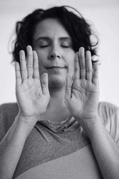 Woman holds up her hands in mindfulness