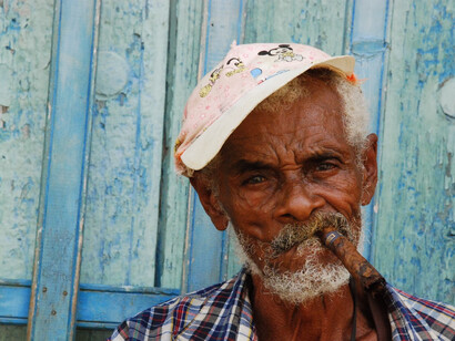 An old Cuban man smoking a Cuban cigar
