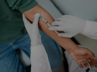 Professional doctor carefully draws a blood sample from a patient, illustrating the importance of medical procedures for diagnosis and treatment in healthcare settings