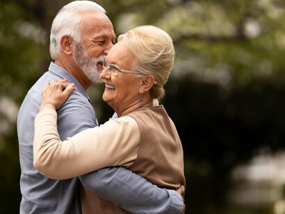 An elderly couple dancing joyfully in the park embodies the essence of physical health, a positive lifestyle, and healthy living