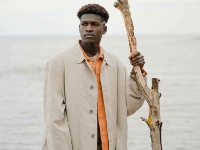 A man alone due to population decline holding onto a wooden stick