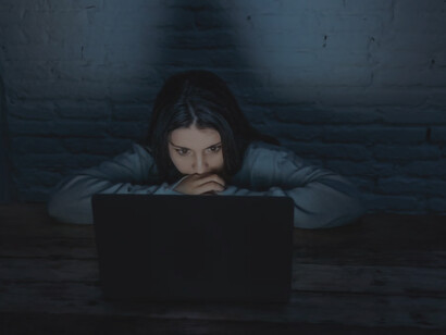 A woman engaged in watching adult content