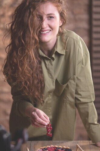 A food influencer capturing herself with a mouthwatering dessert, highlighting culinary trends through engaging social media food blogging