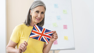 Female English teacher portrait holding an English flag
