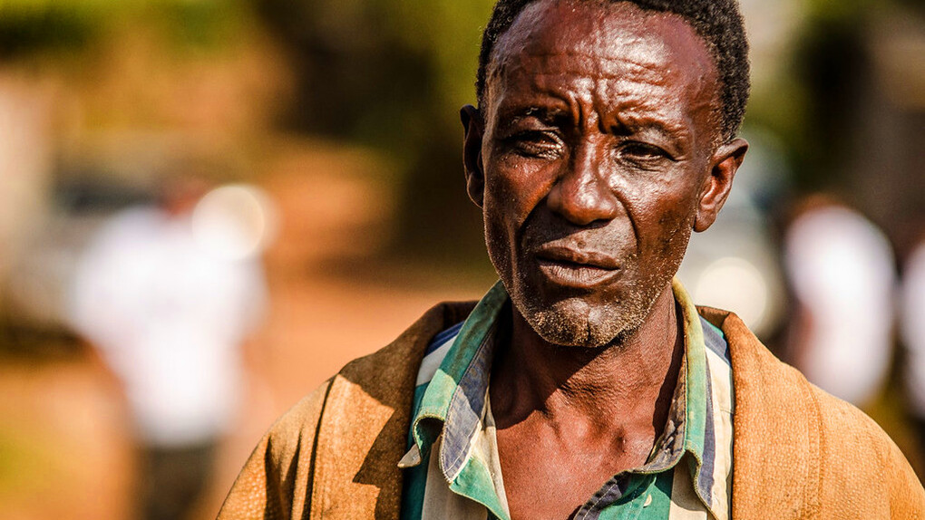 The weight of the world is etched in the lines of his face, a testament to a life shaped by hardship and struggle