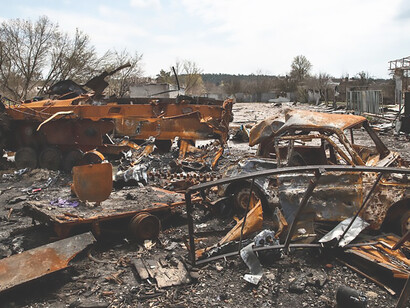 A young girl walks through the aftermath of the Russian invasion in Ukraine