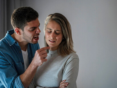 A man and woman arguing at home, experiencing domestic violence, fear, and trauma