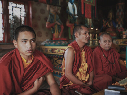 Monks sitting in front of the altar