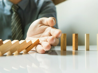 Man catching falling wooden pieces, illustrating the process of learning from mistakes, self-discovery, and personal growth