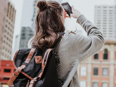 A young woman taking pictures of a city