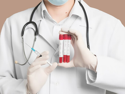 A professional healthcare provider, donning a protective medical mask, is captured holding a syringe and vacutainers, showcasing the meticulousness and expertise essential in medical practices for accurate diagnosis and treatment