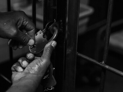 A person unlocking a door, paving the way towards freedom