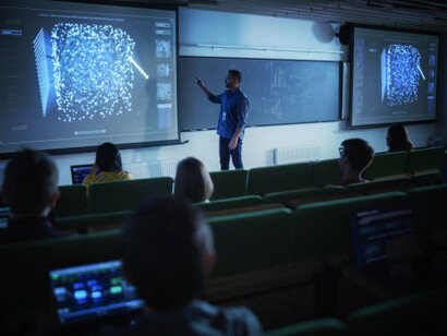 Young university professor presenting on quantum information theory, stochastic resonance, multidimensional scaling, and quantum computing
