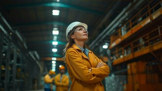 A warehouse manager surveying the production floor, representing the operational readiness required for successful robotics adoption