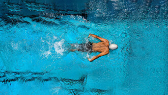 A swimmer gliding through open water, embodying focus and a winning mindset