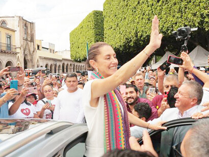 Claudia Sheinbaum, Mexico's newly elected president, waves to supporters, marking a monumental shift in the country's political landscape