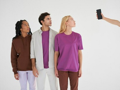 A group of people gathered around a single phone screen, engrossed and showing signs of social media addiction