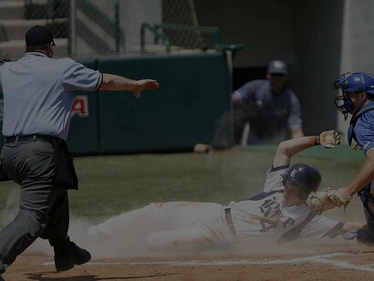 A sliding into home plate college baseball player who the umpire declares he is safe and not out