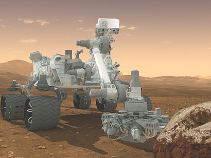 Curiosity landed near the Martian equator about 10:31 p.m., Aug. 5 PDT (1:31 a.m. Aug. 6 EDT) In this picture, the rover examines a rock on Mars with a set of tools at the end of the rover's arm, which extends about 7 feet (2 meters)