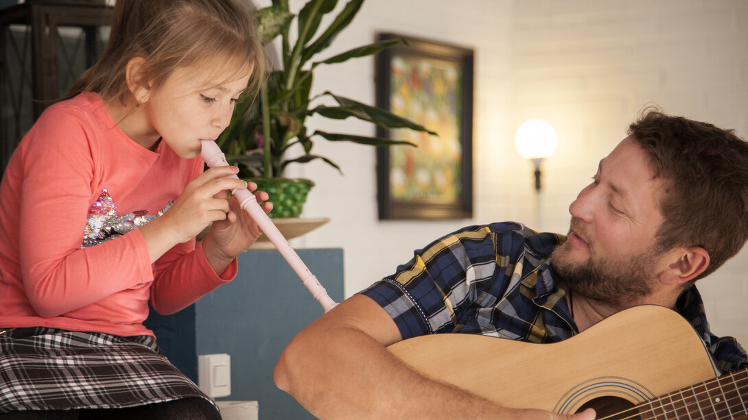 A young girl learning to play the recorder