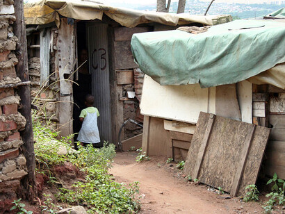 Makeshift shelters and improvised utilities highlight the enduring struggle for adequate housing and infrastructure in urban South Africa