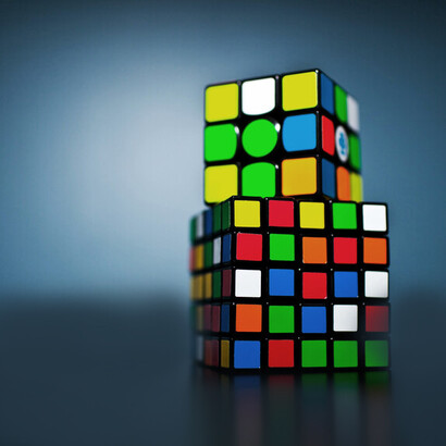 Two Rubik's cubes on top of one another; the five whys is a problem-solving method that involves repeatedly asking "why" to uncover the root cause of an issue