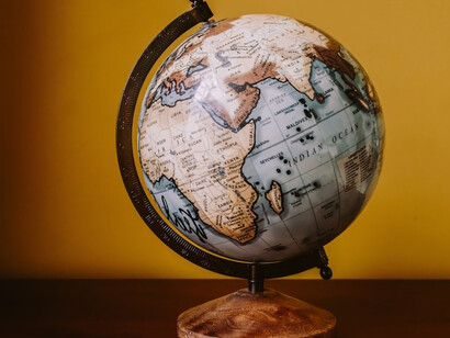 A desk globe characterized by a harmonious blend of brown and white hues in its color palette