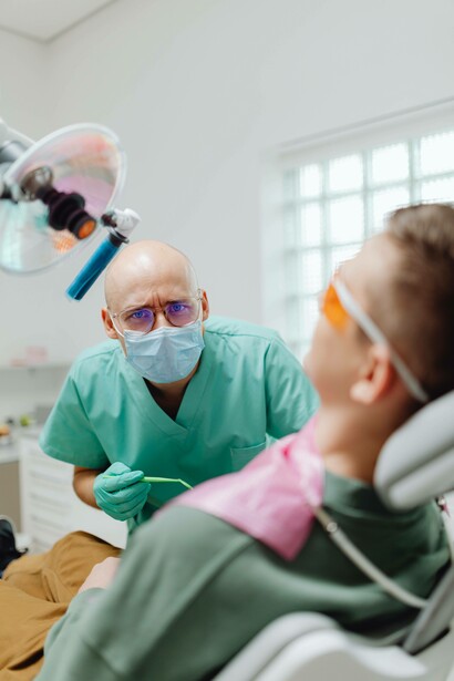 Dentist with mask preparing to observe patient