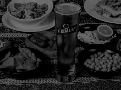 A typical dining out meal in developed countries: beer, chips, snacks, sausages, sandwiches, fries and a very small salad