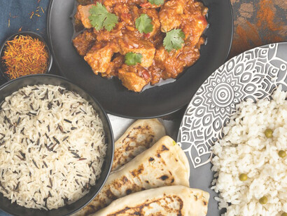 The display features Indian saris alongside traditional Indian cuisine, offering a vibrant showcase of both cultural fashion and culinary delights