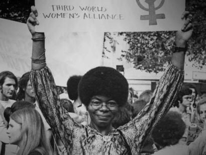Black feminists holding up banners for their cause