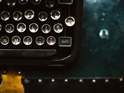 Typewriter's keys on a blue desk