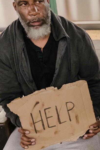 Man holds 'help' sign