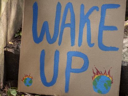 A large sign calling for people to realize how dire the current climate situation is