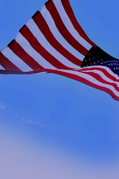 American flag lifted in the sky