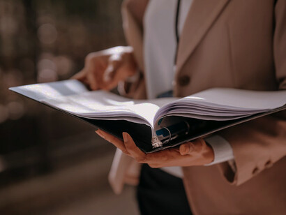 The meticulous process of handling folders underscores the transition from outdated manual systems to the fast, efficient digital procurement tools of today