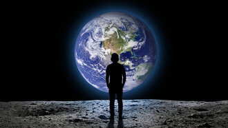 Teenager viewed from behind gazing at planet Earth from outer space