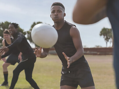 Vibrant image depicting men in action playing rugby on a field in Kenya, showcasing the dynamic spirit of the sport