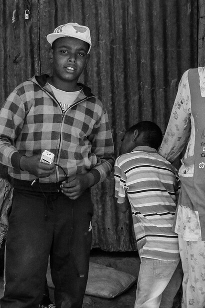 Young men hangout in slum neighbourhood