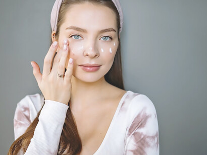 Delve into the world of skincare essentials with a captivating image of a woman embracing her routine, applying cream for a flawless, glowing complexion
