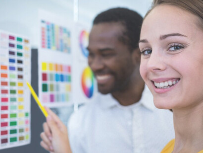 Office workers using color psychology and a palette to optimize productivity and atmosphere through strategic color application