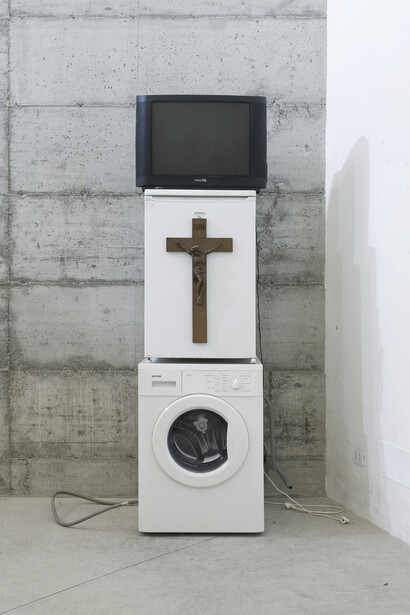 Danh Võ, Oma Totem, 2009, Phillips 26 inch TV, Goenje washing machine, Bomann, refrigerator, wooden crucifix, Nguyen Thi Ty’s personalized
entrance card for a casino