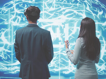 Professionals working together on laptops and tablets, leveraging AI software to address complex tasks